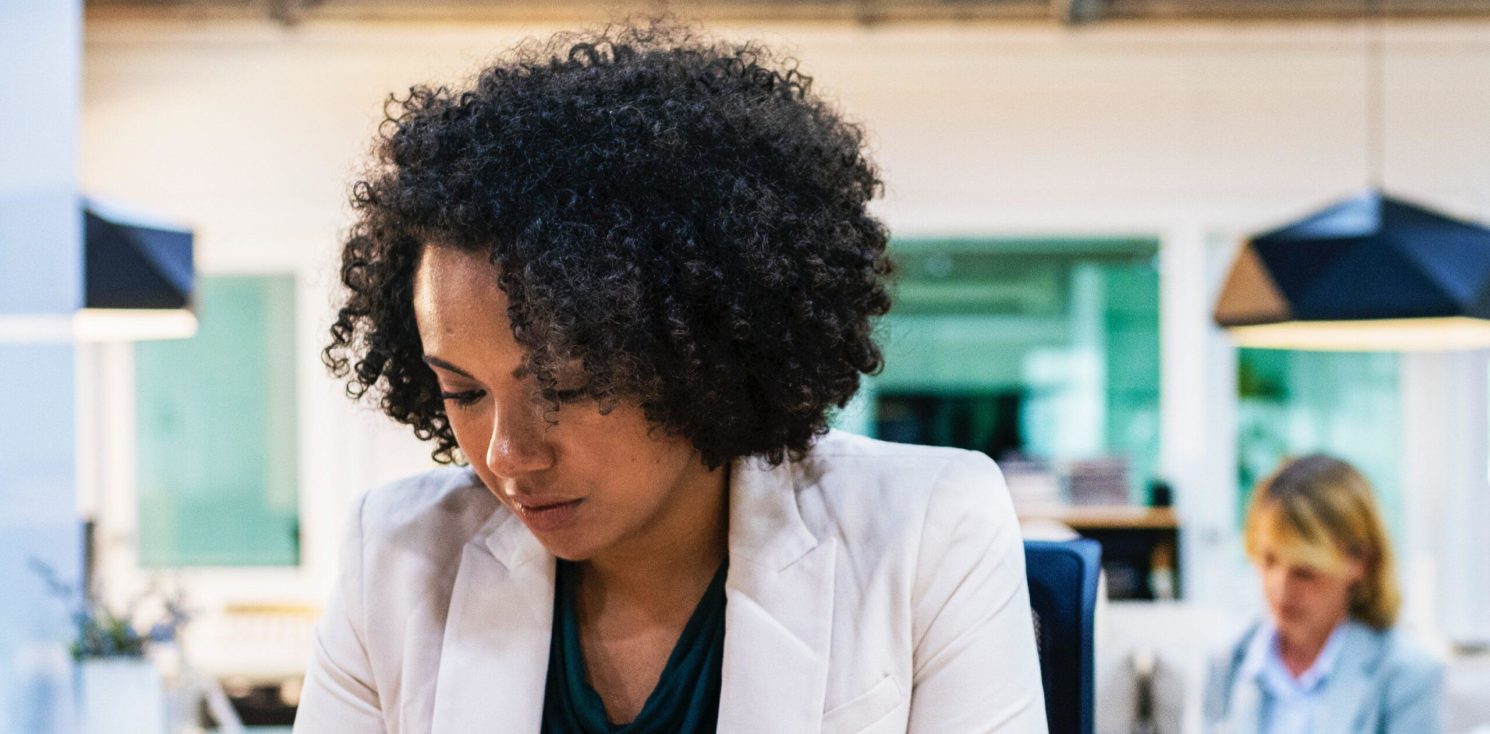 A business woman checks her phone
