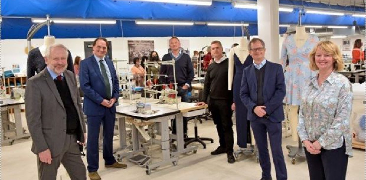 Fashion Academy opening. Central table with. Sowing machine threads and guests around it