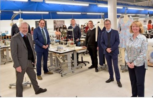 Fashion Academy opening. Central table with. Sowing machine threads and guests around it