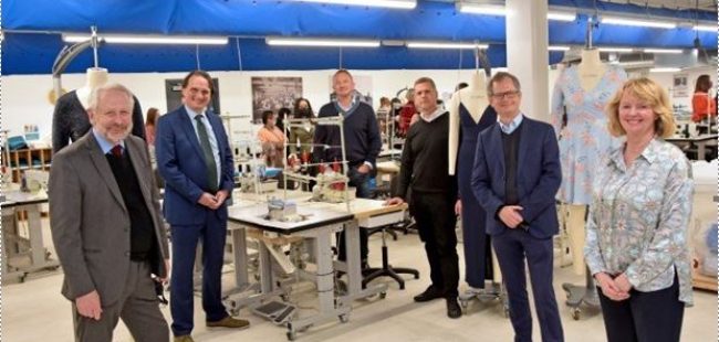 Fashion Academy opening. Central table with. Sowing machine threads and guests around it
