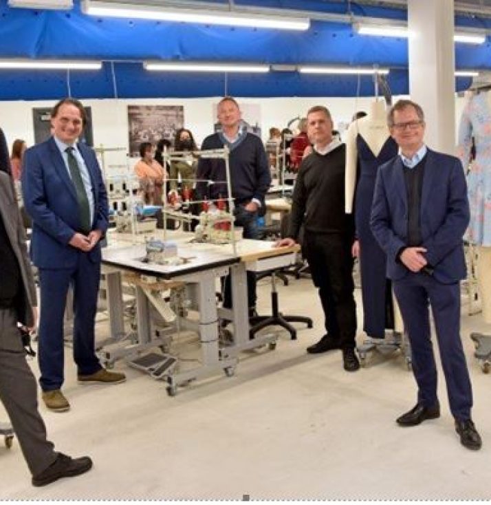 Fashion Academy opening. Central table with. Sowing machine threads and guests around it