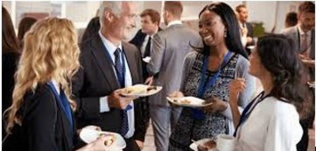 People networking with drinks and some snacks